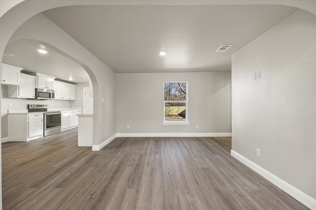 unfurnished living room with hardwood / wood-style floors