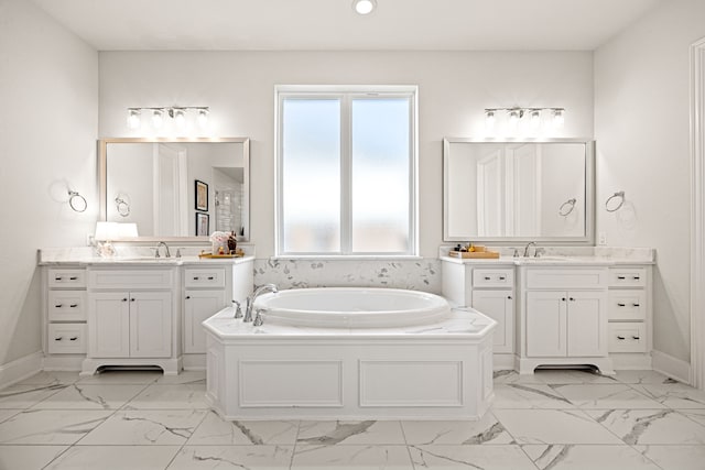 bathroom with vanity and a bath