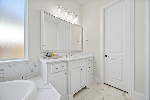 bathroom with vanity and a washtub