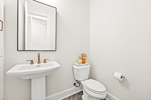 bathroom with sink, wood-type flooring, and toilet