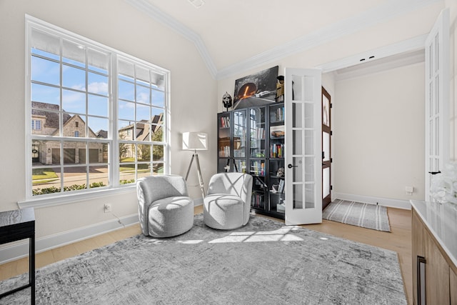 sitting room featuring hardwood / wood-style floors, ornamental molding, and french doors