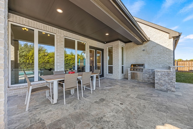 view of patio / terrace with area for grilling and a grill