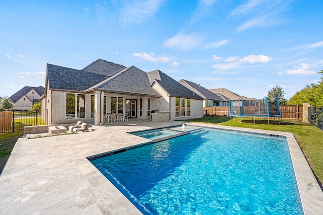 view of pool with a patio area and a trampoline