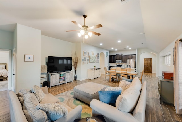 living room featuring ceiling fan, lofted ceiling, and hardwood / wood-style floors