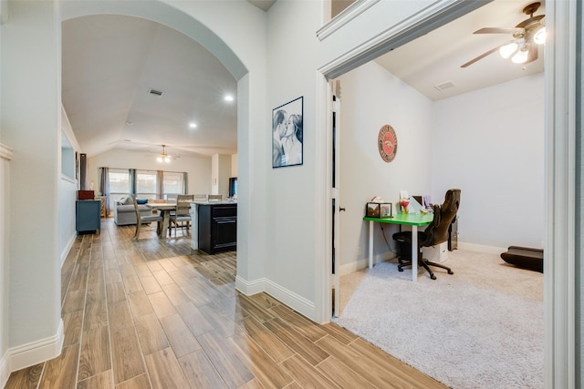 corridor featuring vaulted ceiling and hardwood / wood-style floors