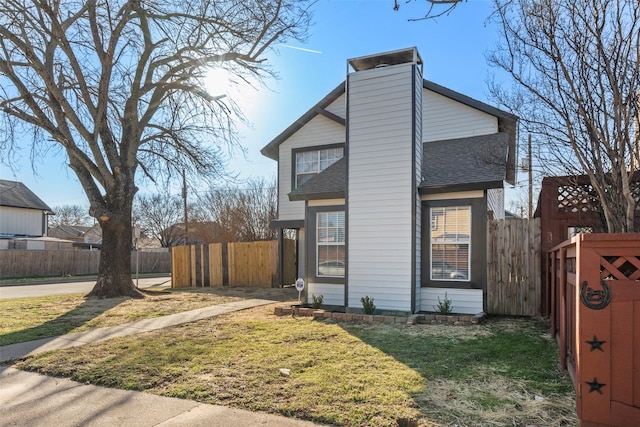 view of side of home with a lawn