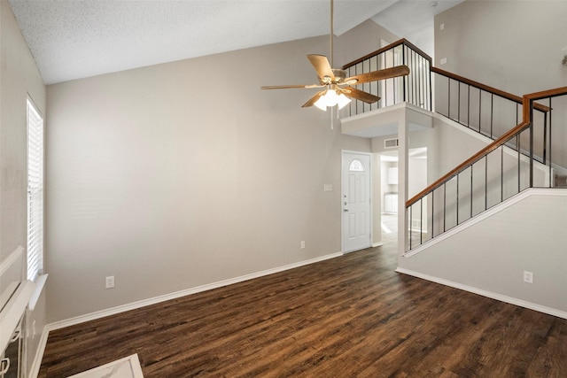 entryway with a textured ceiling, high vaulted ceiling, dark hardwood / wood-style floors, and ceiling fan