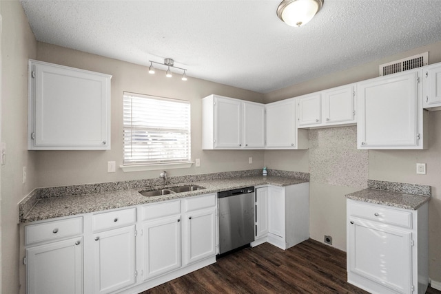 kitchen with sink, a textured ceiling, white cabinets, dark hardwood / wood-style flooring, and stainless steel dishwasher