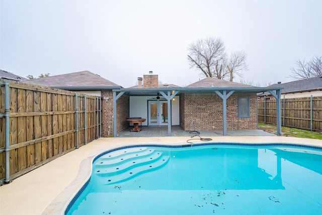 view of pool featuring french doors, ceiling fan, and a patio