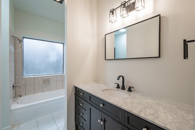 bathroom featuring vanity, tiled shower / bath combo, and tile patterned floors