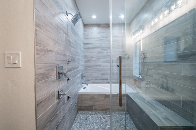 bathroom featuring independent shower and bath