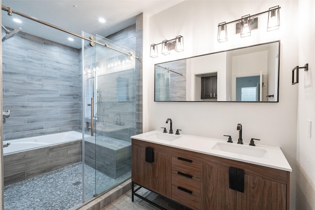 bathroom featuring independent shower and bath and vanity