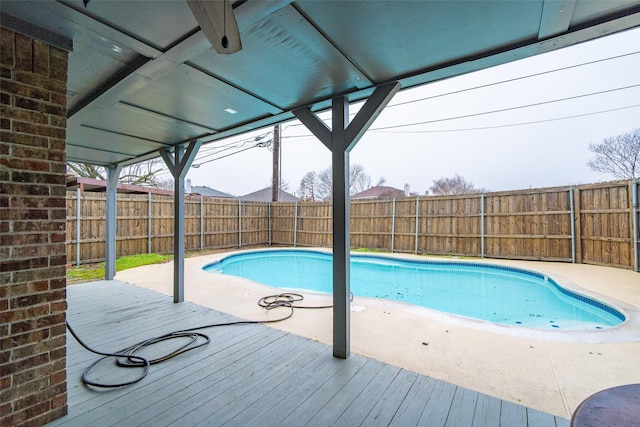 view of swimming pool with a wooden deck