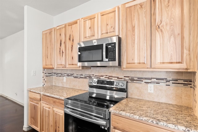 kitchen featuring appliances with stainless steel finishes and light brown cabinetry