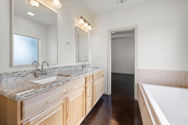 full bath with double vanity, visible vents, a washtub, and a sink