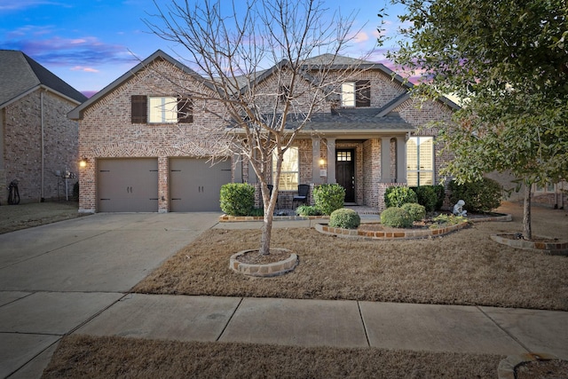 view of front of home with a porch and a garage