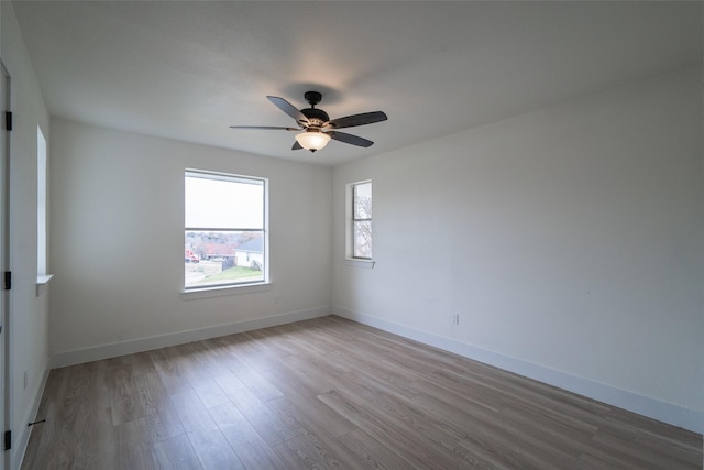 unfurnished room featuring ceiling fan and light wood-type flooring