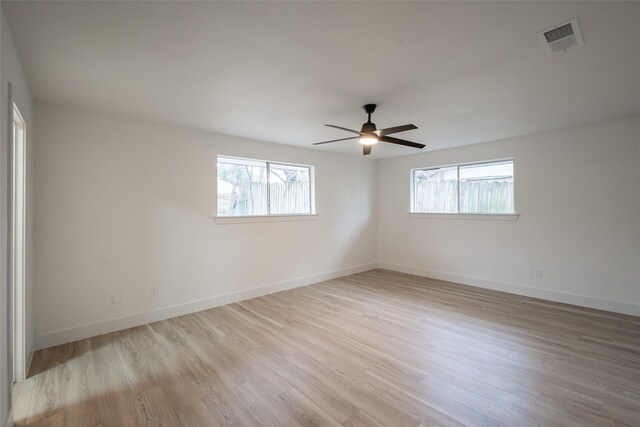 spare room featuring light hardwood / wood-style flooring and ceiling fan