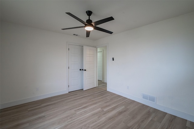 unfurnished bedroom with a closet, ceiling fan, and light hardwood / wood-style flooring