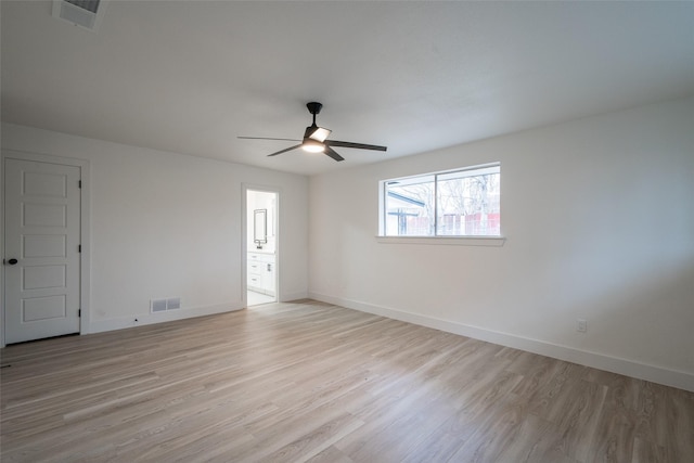 empty room with ceiling fan and light hardwood / wood-style flooring