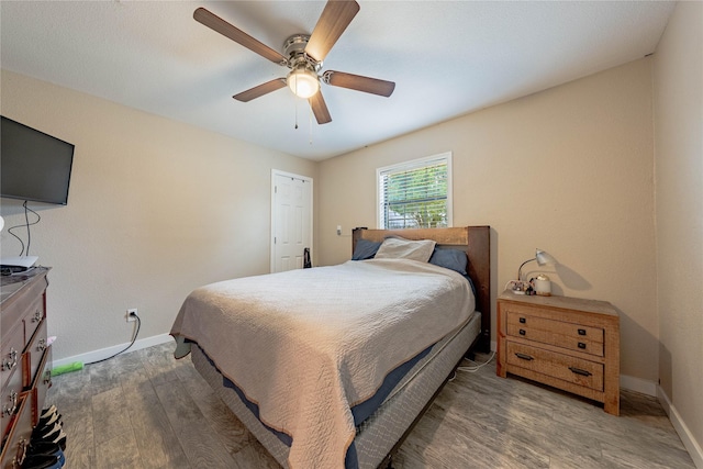 bedroom with hardwood / wood-style floors and ceiling fan