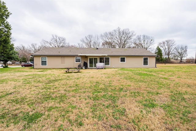 back of property featuring a yard