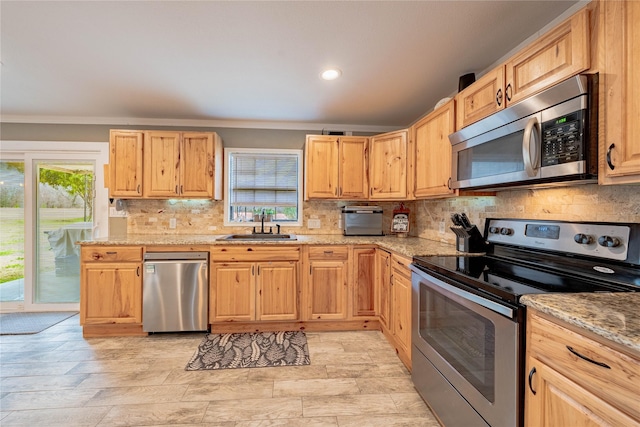 kitchen featuring sink, backsplash, stainless steel appliances, light stone countertops, and light brown cabinets