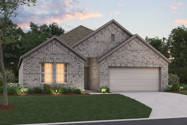 view of front facade with a garage and a lawn