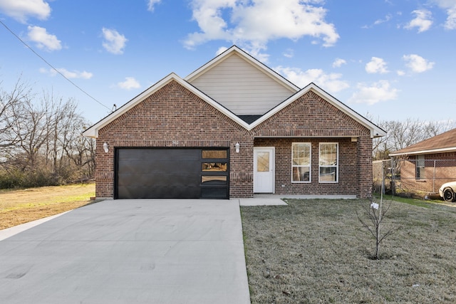 view of front of property featuring a garage and a front lawn