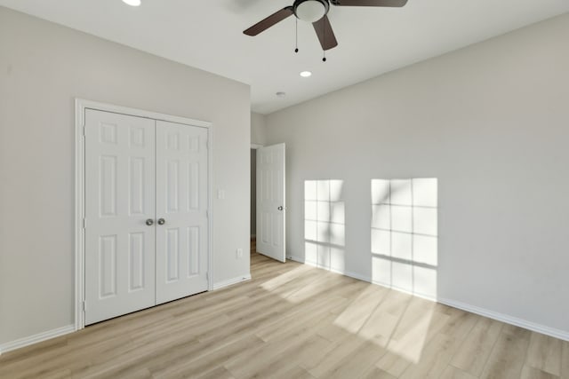 unfurnished bedroom featuring light hardwood / wood-style flooring, a closet, and ceiling fan