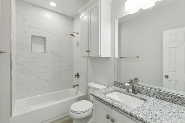 full bathroom with vanity, toilet, and tiled shower / bath combo