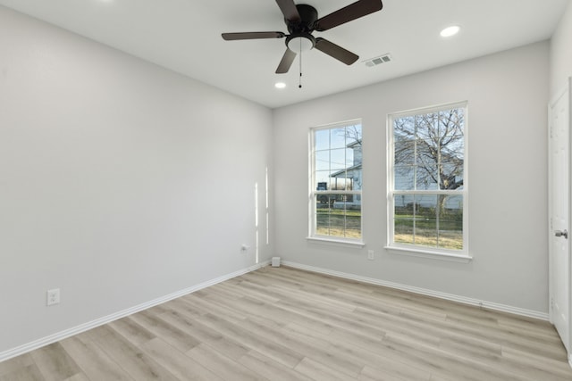 empty room featuring ceiling fan and light wood-type flooring