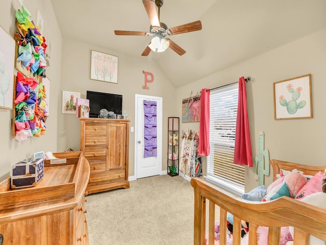 carpeted bedroom with ceiling fan and vaulted ceiling