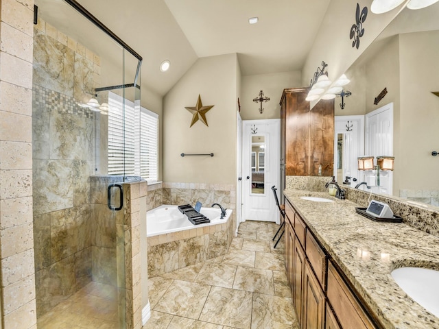 bathroom featuring vaulted ceiling, vanity, and separate shower and tub