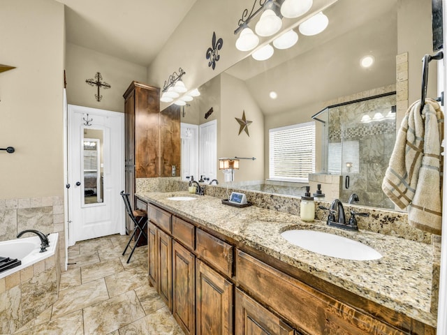 bathroom with lofted ceiling, vanity, and shower with separate bathtub