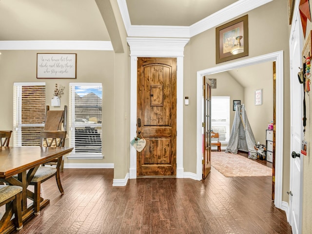 entrance foyer with ornamental molding and dark hardwood / wood-style flooring