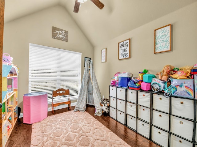 playroom with vaulted ceiling, dark wood-type flooring, and ceiling fan