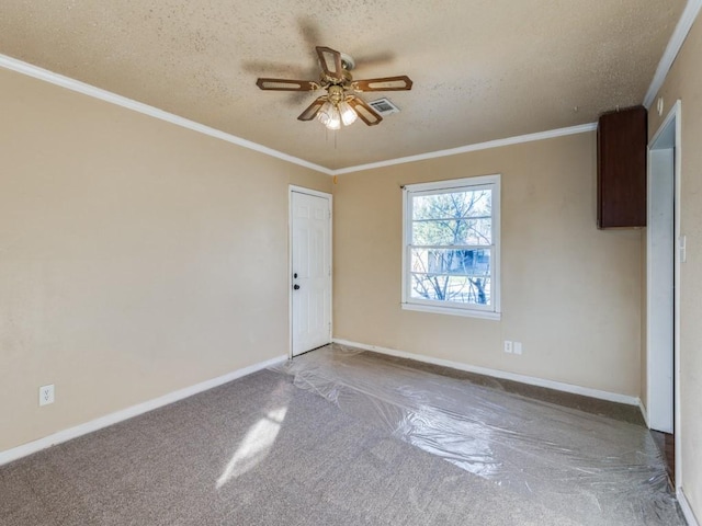 carpeted empty room featuring crown molding, ceiling fan, and a textured ceiling