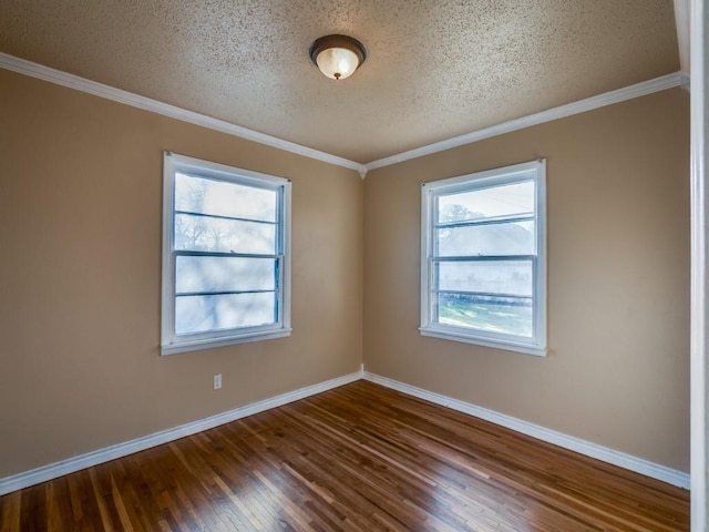 spare room featuring ornamental molding, hardwood / wood-style floors, and a textured ceiling