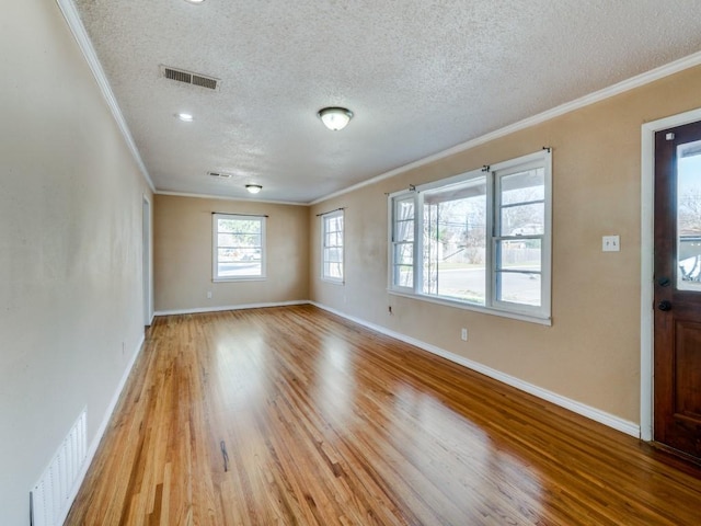 entrance foyer featuring crown molding, light hardwood / wood-style floors, and a textured ceiling