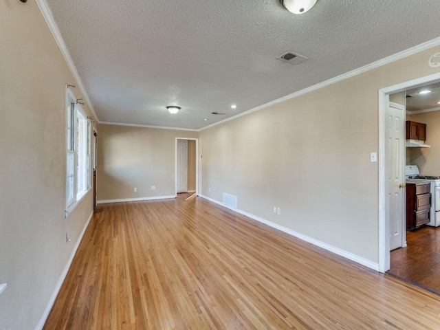 spare room featuring ornamental molding, a textured ceiling, and light wood-type flooring