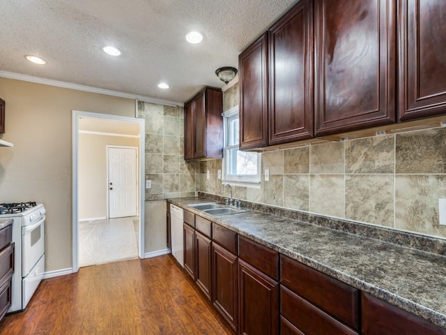 kitchen with dark hardwood / wood-style floors, sink, backsplash, ornamental molding, and white appliances