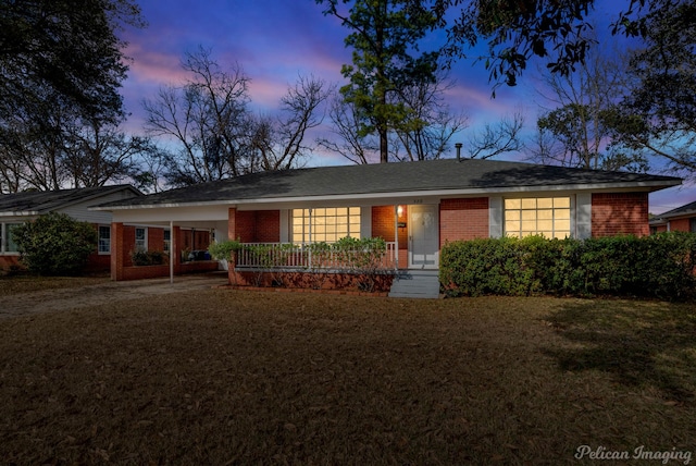 single story home with brick siding and a front lawn