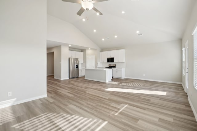 unfurnished living room featuring high vaulted ceiling, ceiling fan, and light wood-type flooring