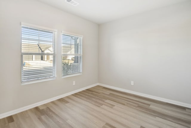 unfurnished room with light hardwood / wood-style floors