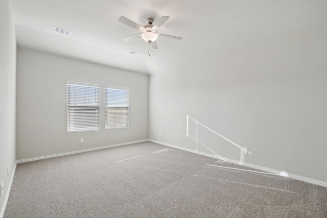 carpeted spare room with lofted ceiling and ceiling fan