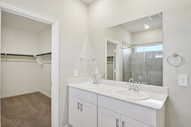 bathroom with walk in shower and vanity