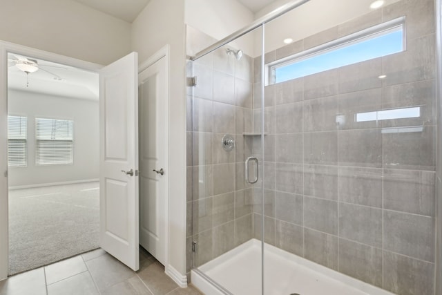 bathroom with tile patterned flooring, an enclosed shower, and ceiling fan