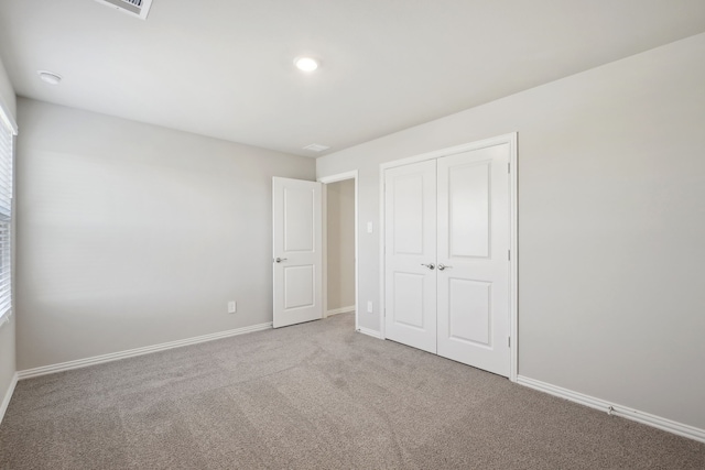 unfurnished bedroom with a closet and carpet