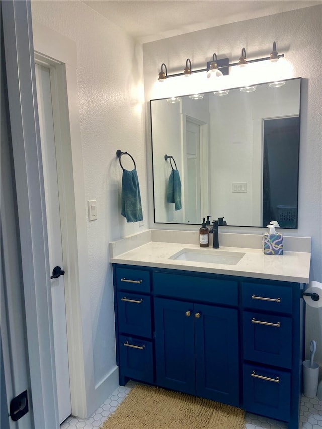 bathroom with tile patterned flooring and vanity